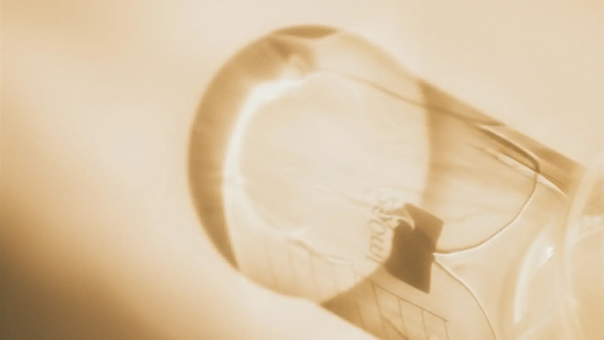 Longevity & Rejuvenation: Close-up of a clear dropper or vial, illuminated by a warm glow.