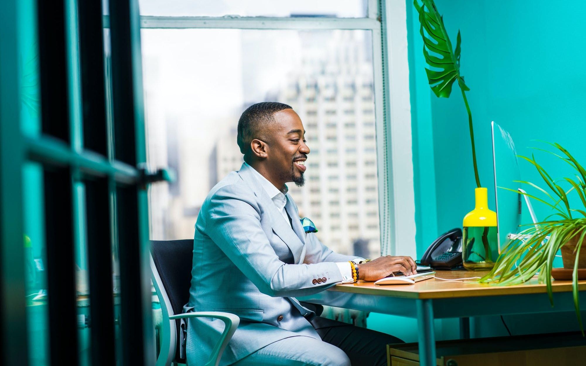 a guy in a suit using a computer