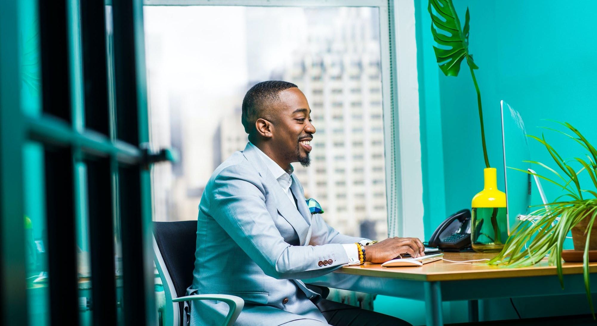 a guy in a suit using a computer