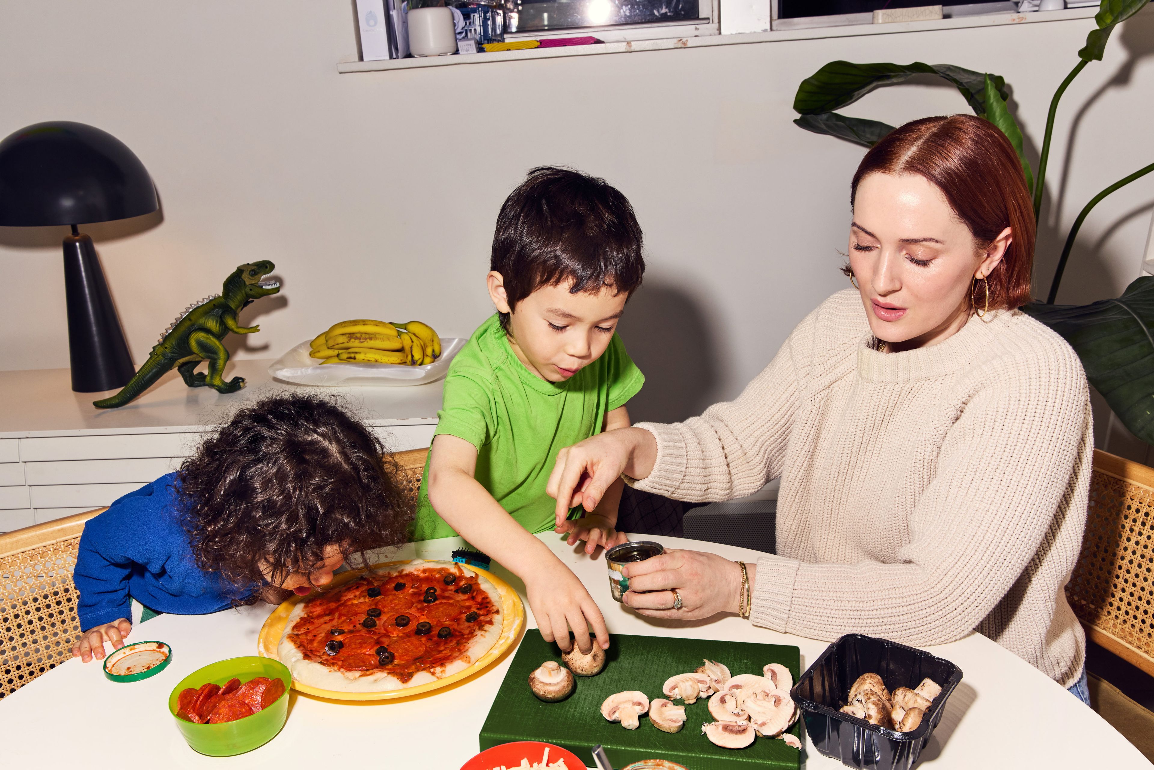 Parent and children making a pizza