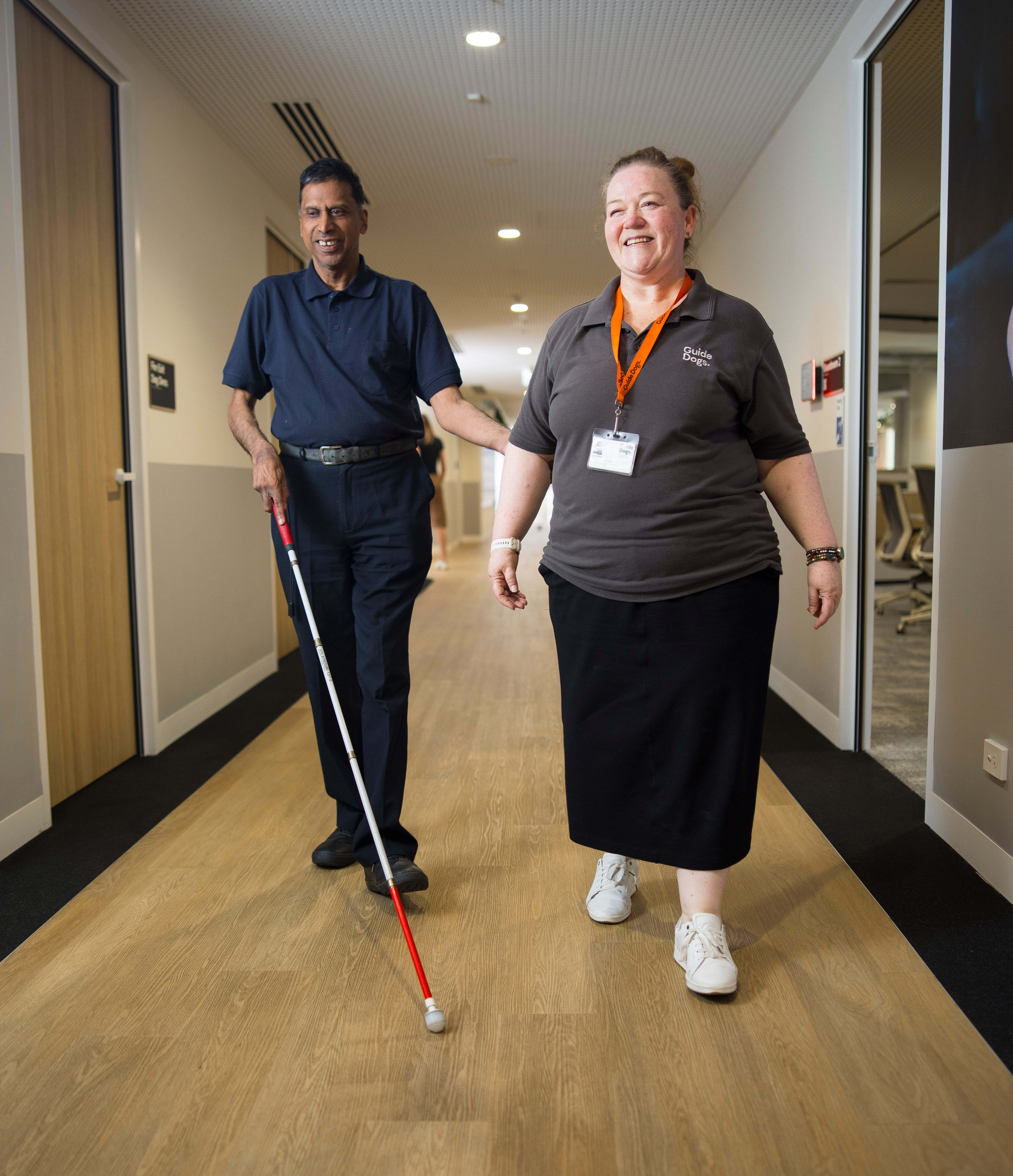 A Guide Dogs staff member walking with a Client