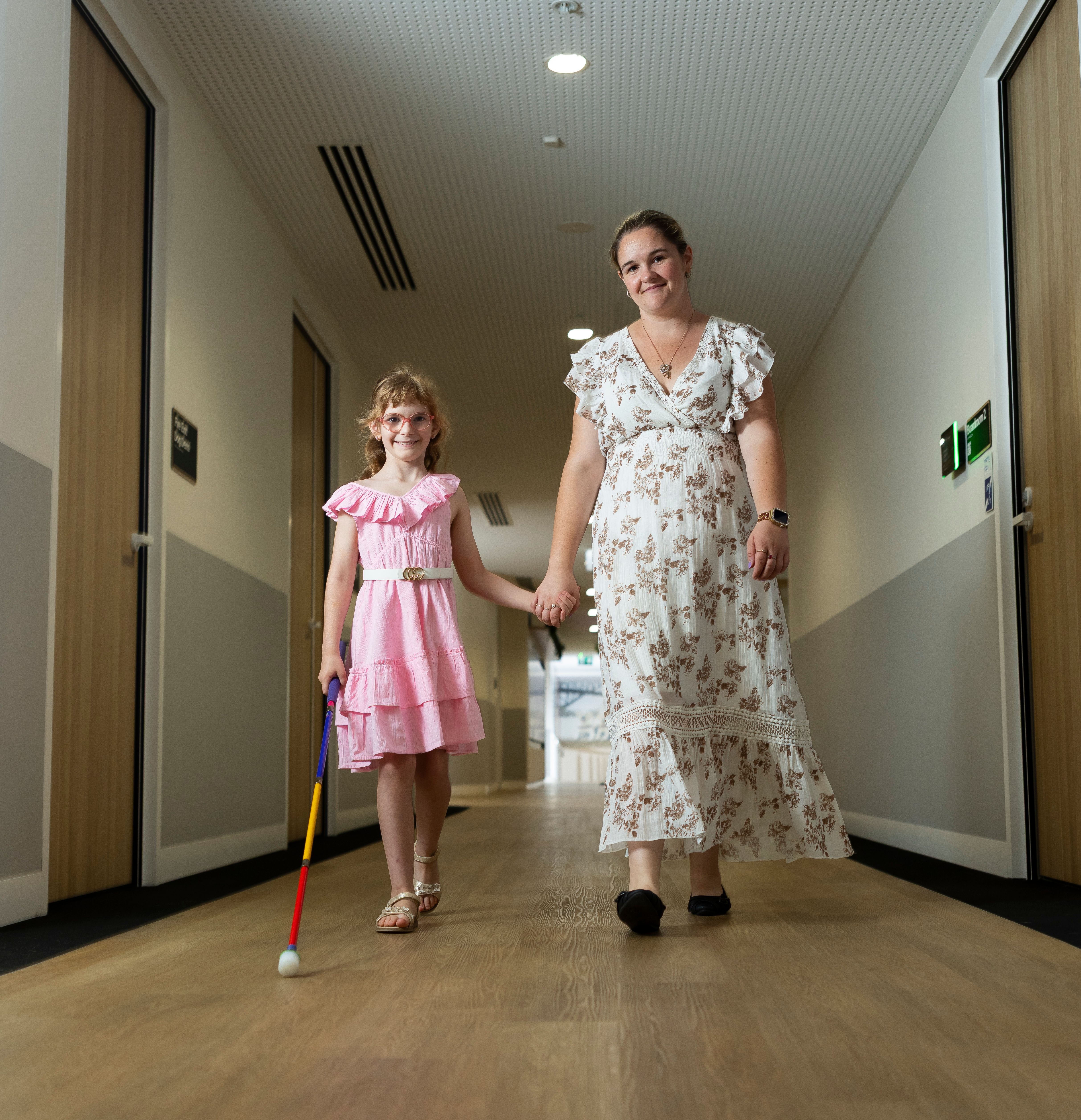 A child and her mum walking. 