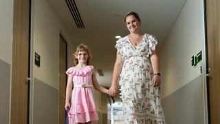 A child and her mum walking.