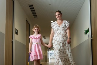 A child and her mum walking.