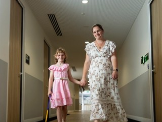 A child and her mum walking.