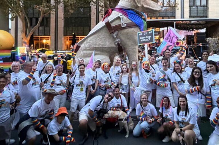 Guide Dogs team and volunteers and Clients standing and smiling together.