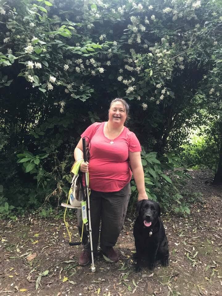 Lee standing with Guide Dog Frankie.