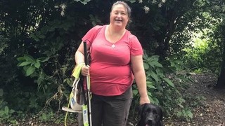 Lee standing with Guide Dog Frankie.