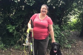 Lee standing with Guide Dog Frankie.