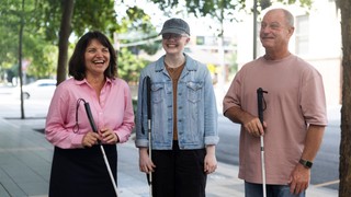 A group of people with canes standing together.