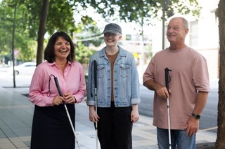 A group of people with canes standing together.