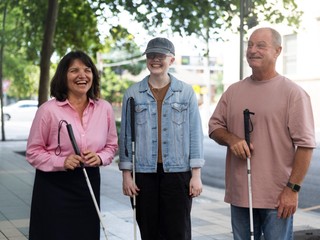 A group of people with canes standing together.