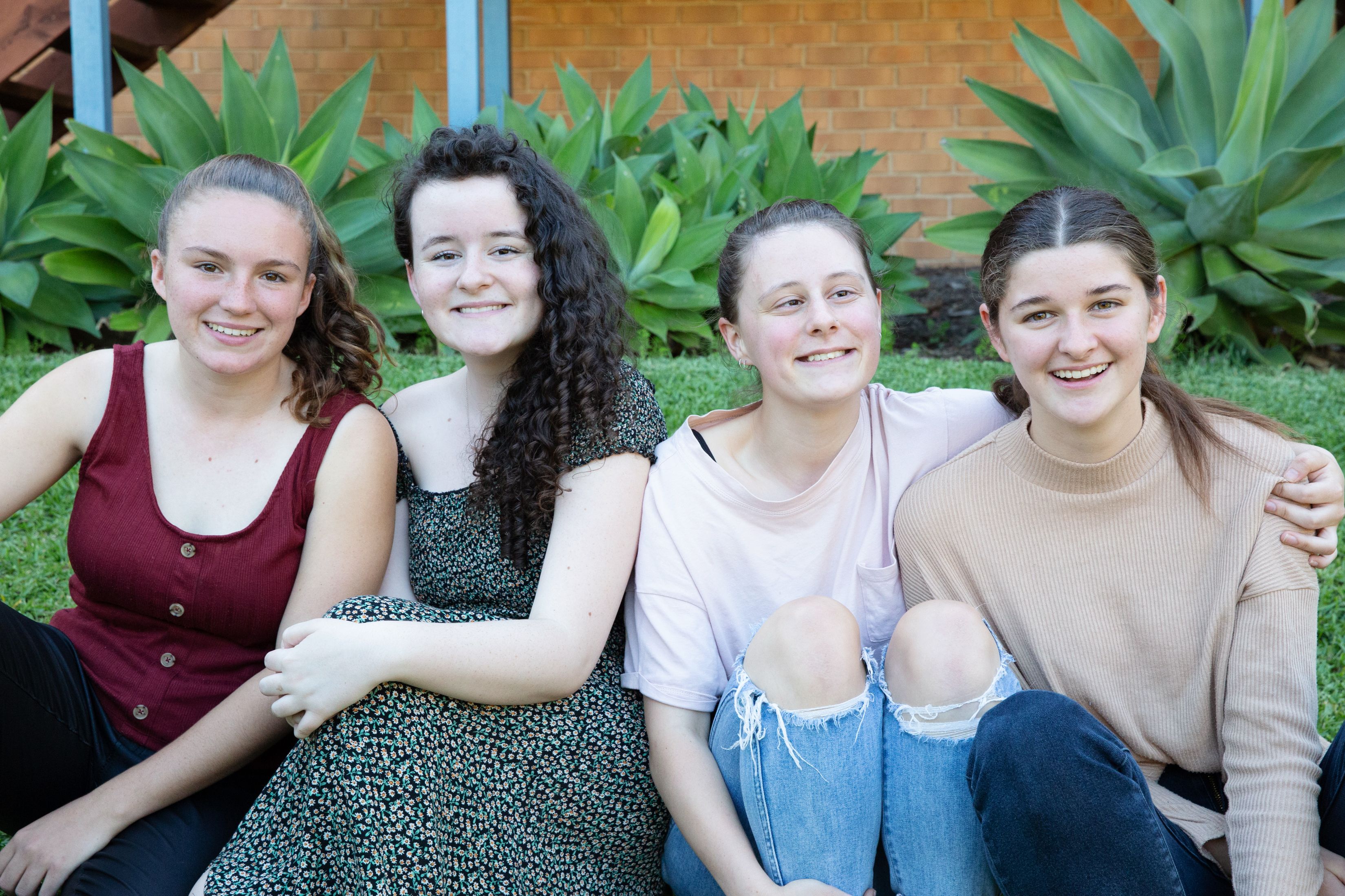 A group of young people sitting together.