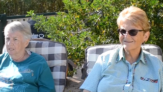 Two sisters sitting next to each other.