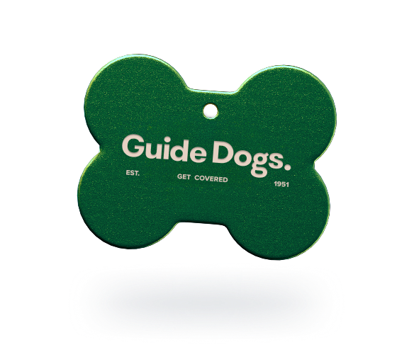Image of a dog tag with the words Guide Dogs imprinted