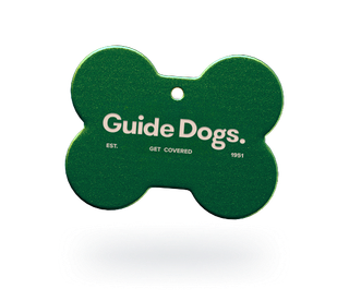 Image of a dog tag with the words Guide Dogs imprinted