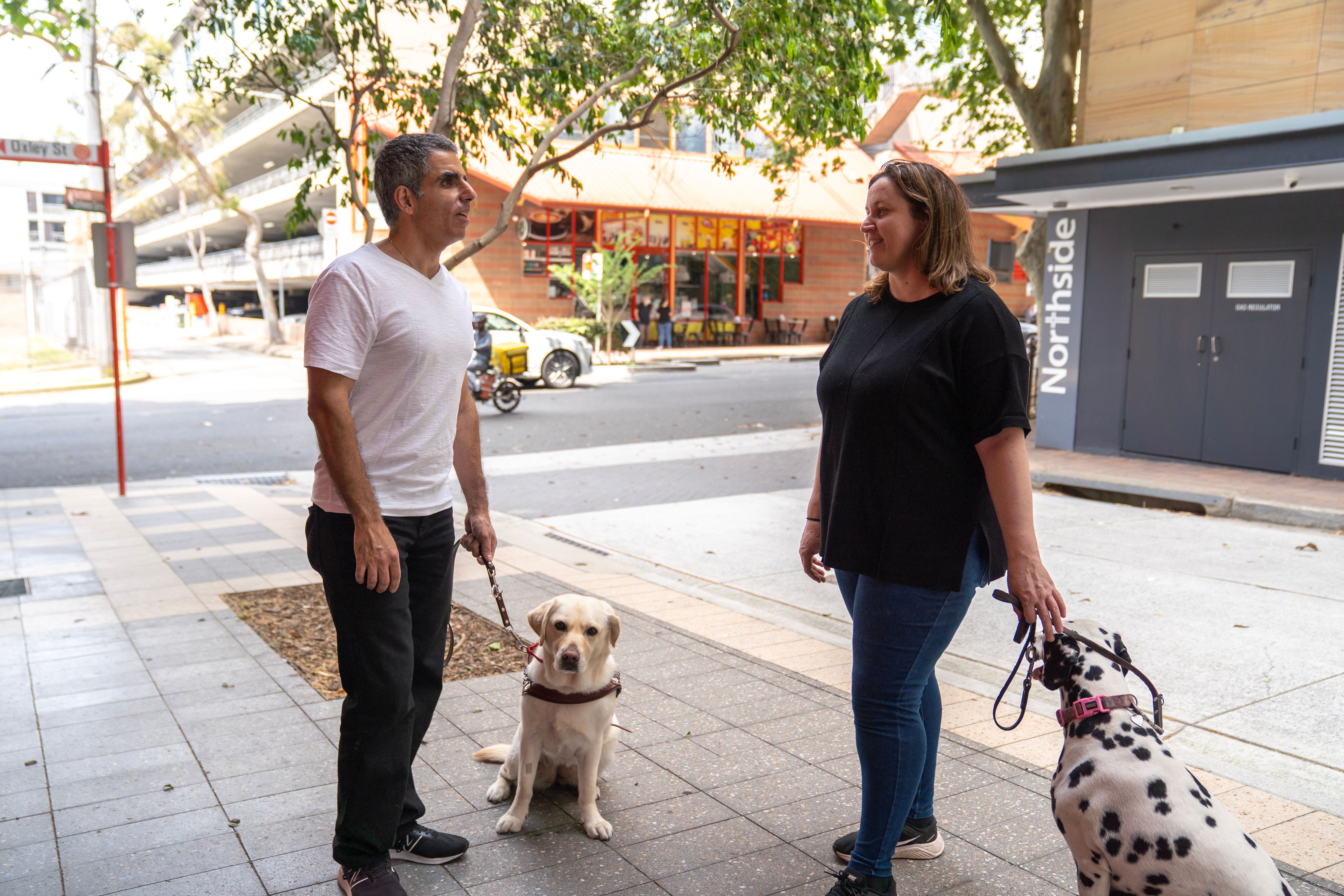 A person talking to a Guide Dog Handler.