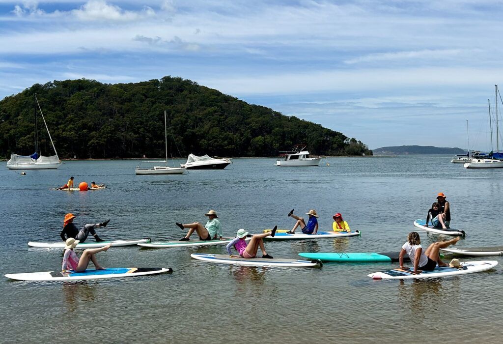 People on paddle boards practicing yoga.