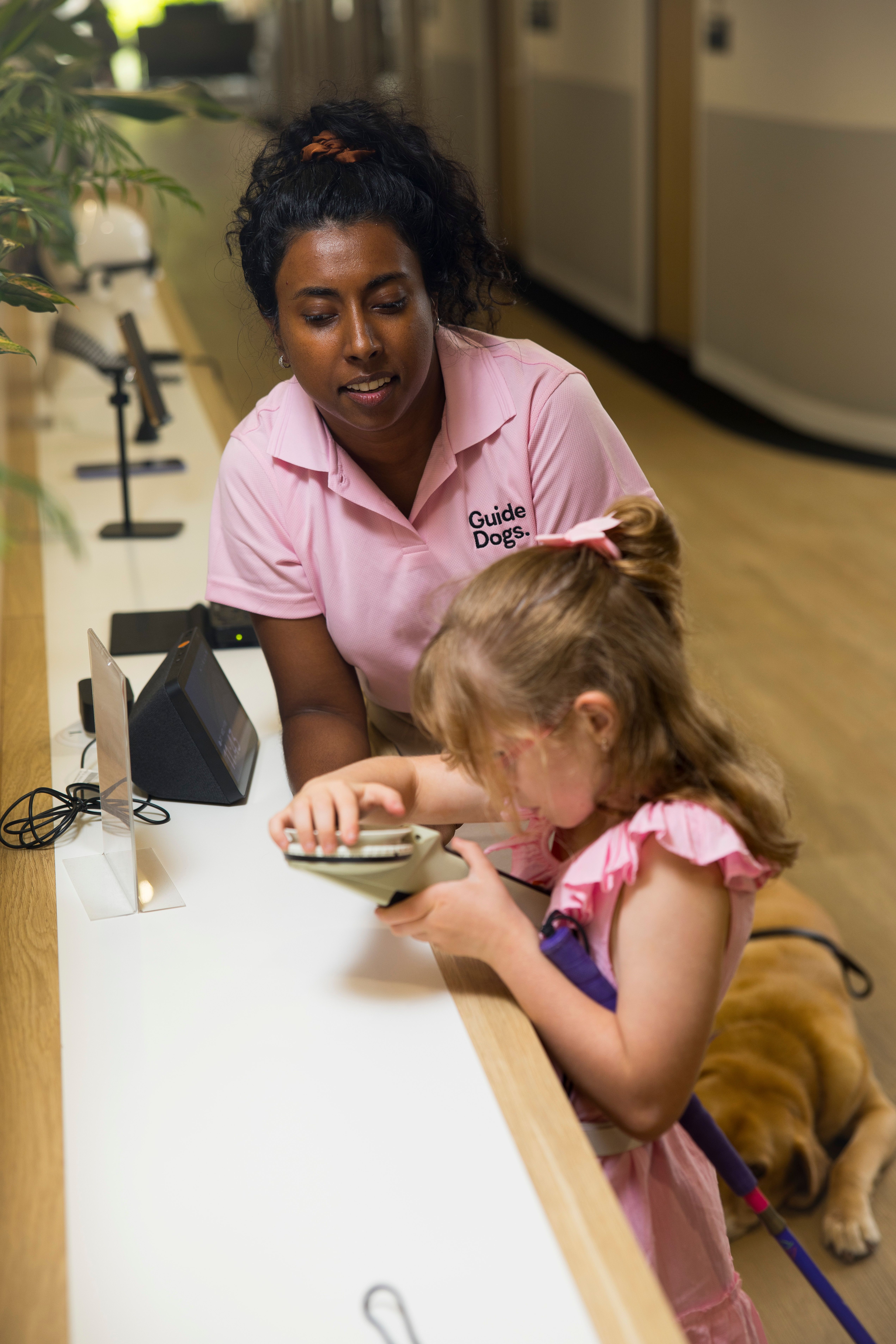 Assistive Technology Specialist Abby assisting a child at the AT helpdesk.