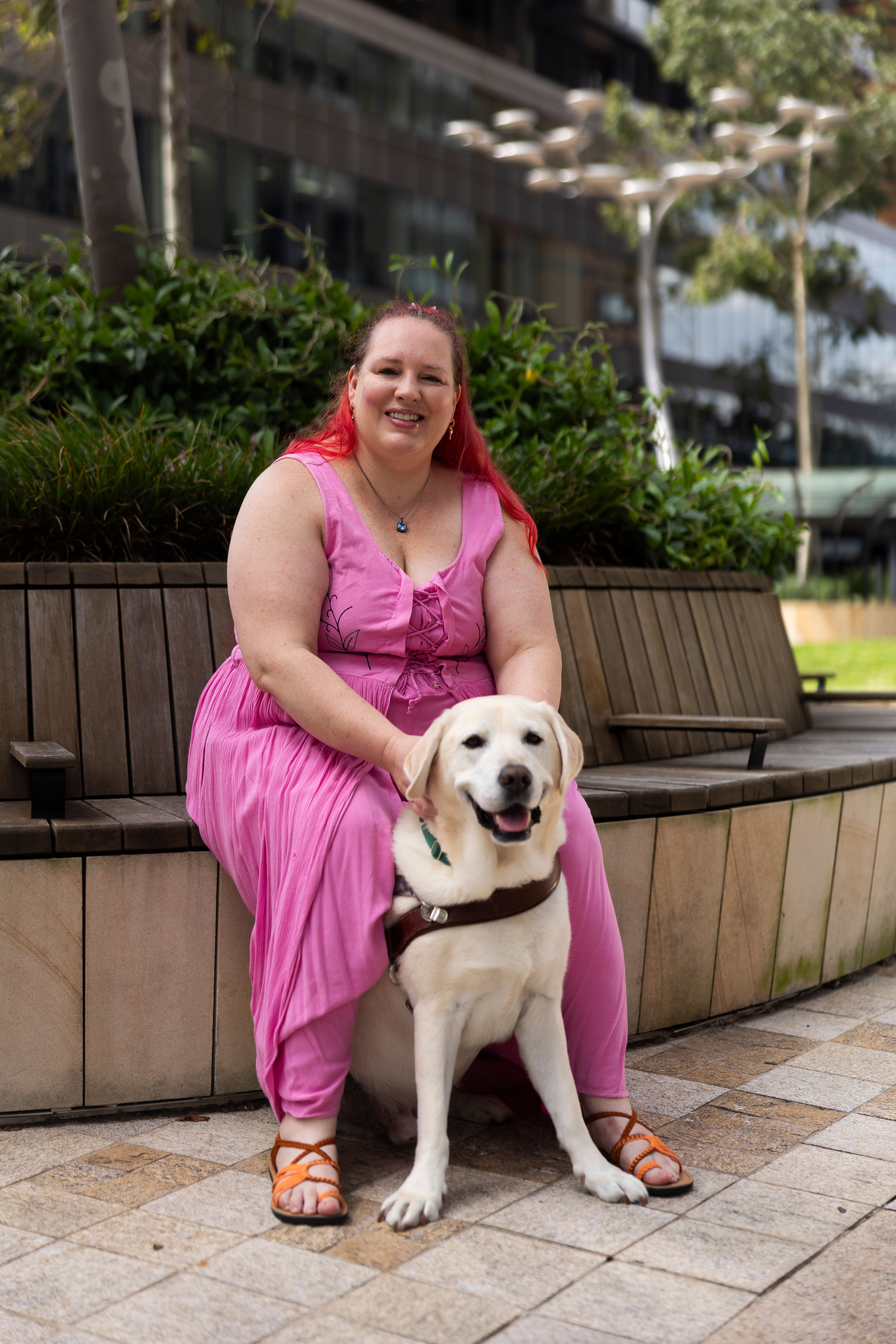 A Guide Dog Handler with her yellow Guide Dog. 