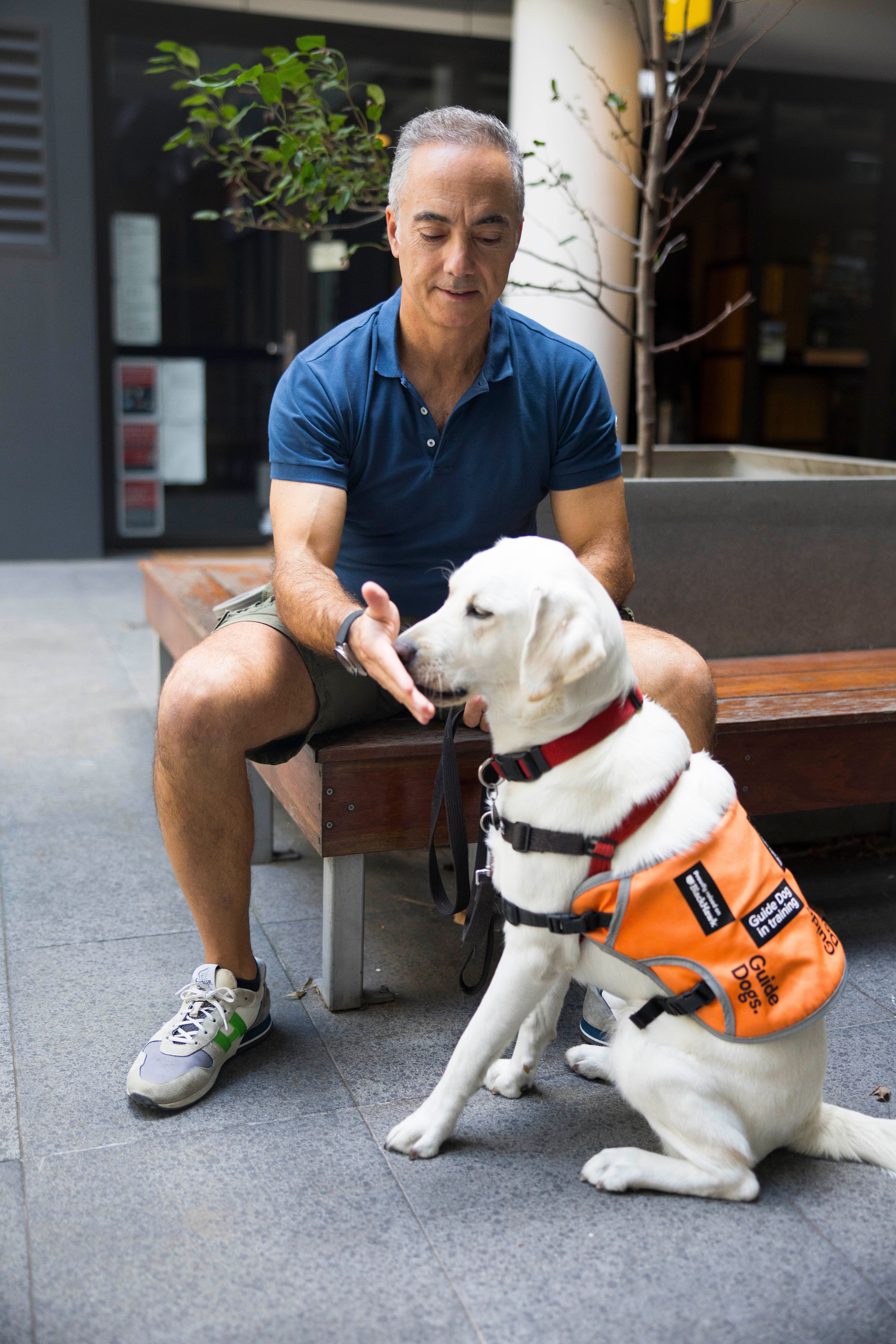 A Puppy Raiser sitting with their dog.