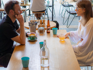 Two people sitting in a cafe.
