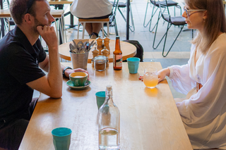 Two people sitting in a cafe.