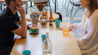 Two people sitting in a cafe.