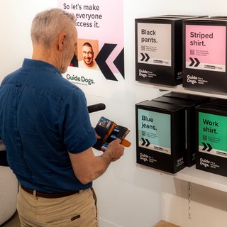 A person looking at boxes at Blackout Friday.