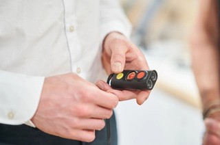 A person holding a miniguide.