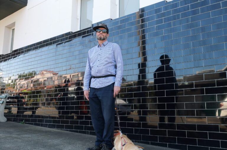 Brian standing with his Guide Dog Quanti.