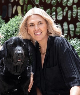 Kristie sitting next to Ambassador Dog Fella