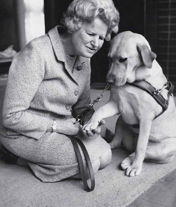 Elsie mead kneeling next to her Guide Dog Beau.