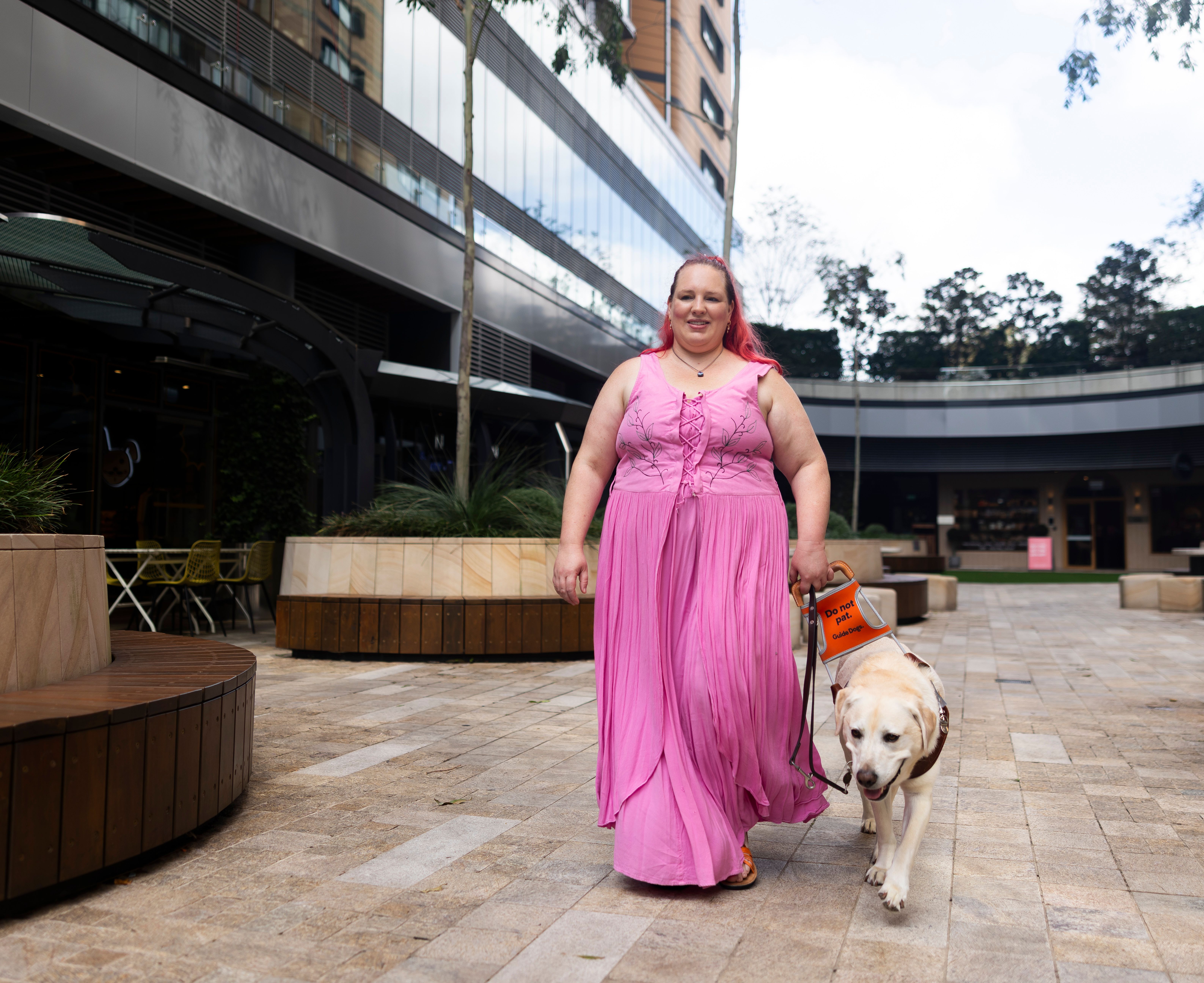 A person walking with their Guide Dog. 