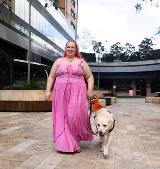 A Handler walking with their Guide Dog.