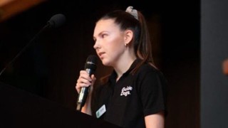 Karlee symonds speaking at a school.