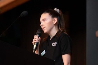 Karlee symonds speaking at a school.