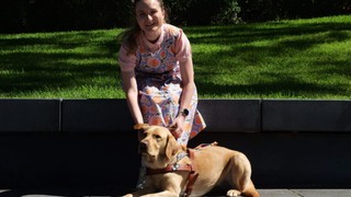 Charlotte sitting with her Guide Dog Bronte.