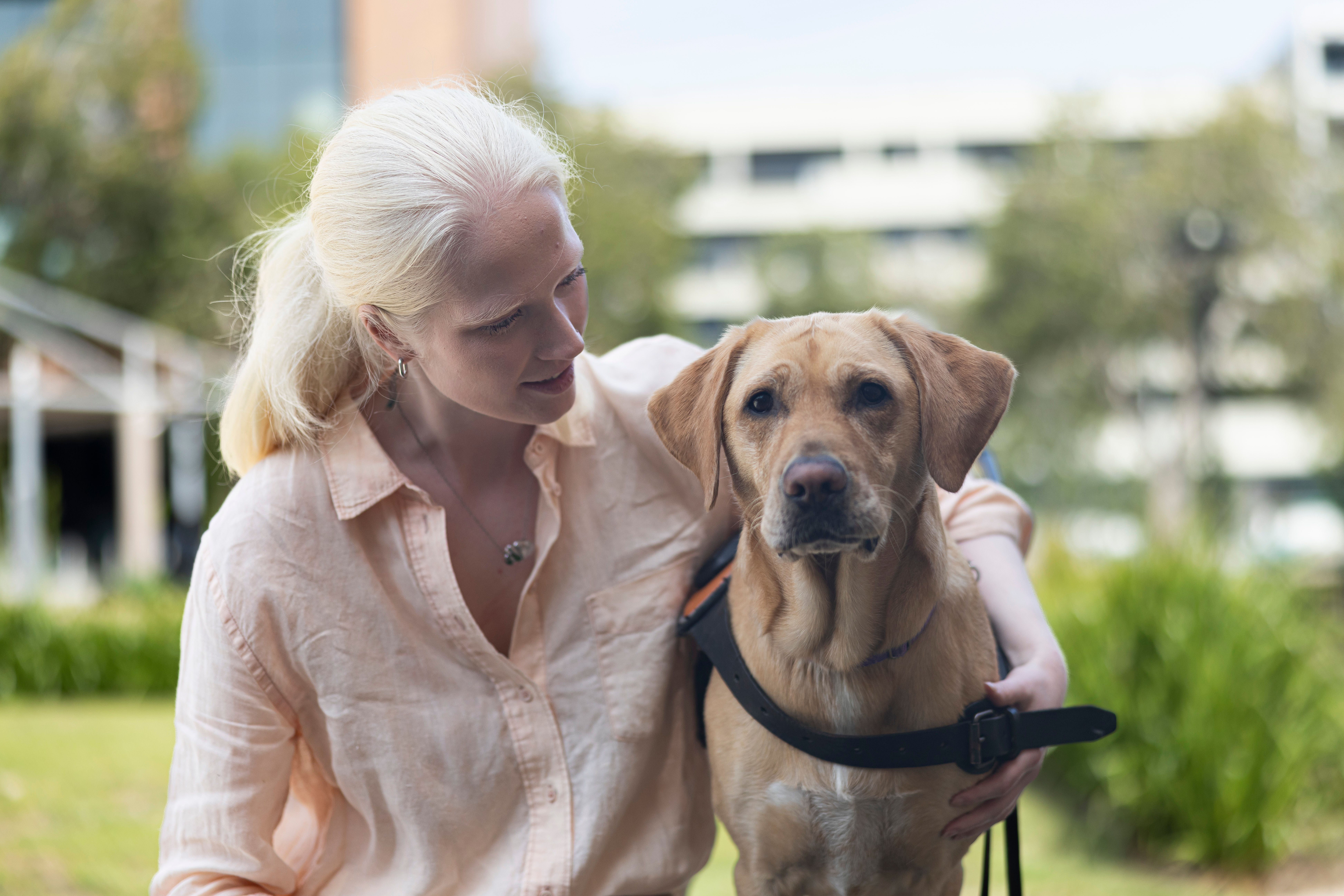 Guide Dog Lorraine and Sacha sitting together.