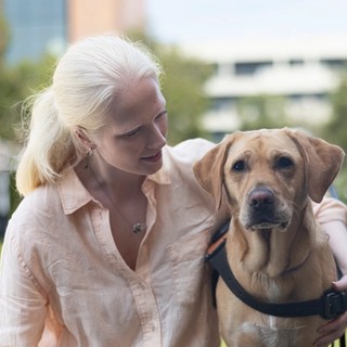 Guide Dog Lorraine and Sacha sitting together.