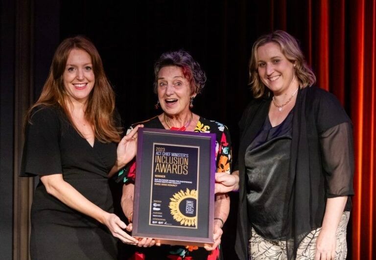 Tamara Searant and Di Shaddock standing with an award recipient.