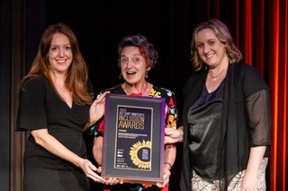 Tamara Searant and Di Shaddock standing with an award recipient.