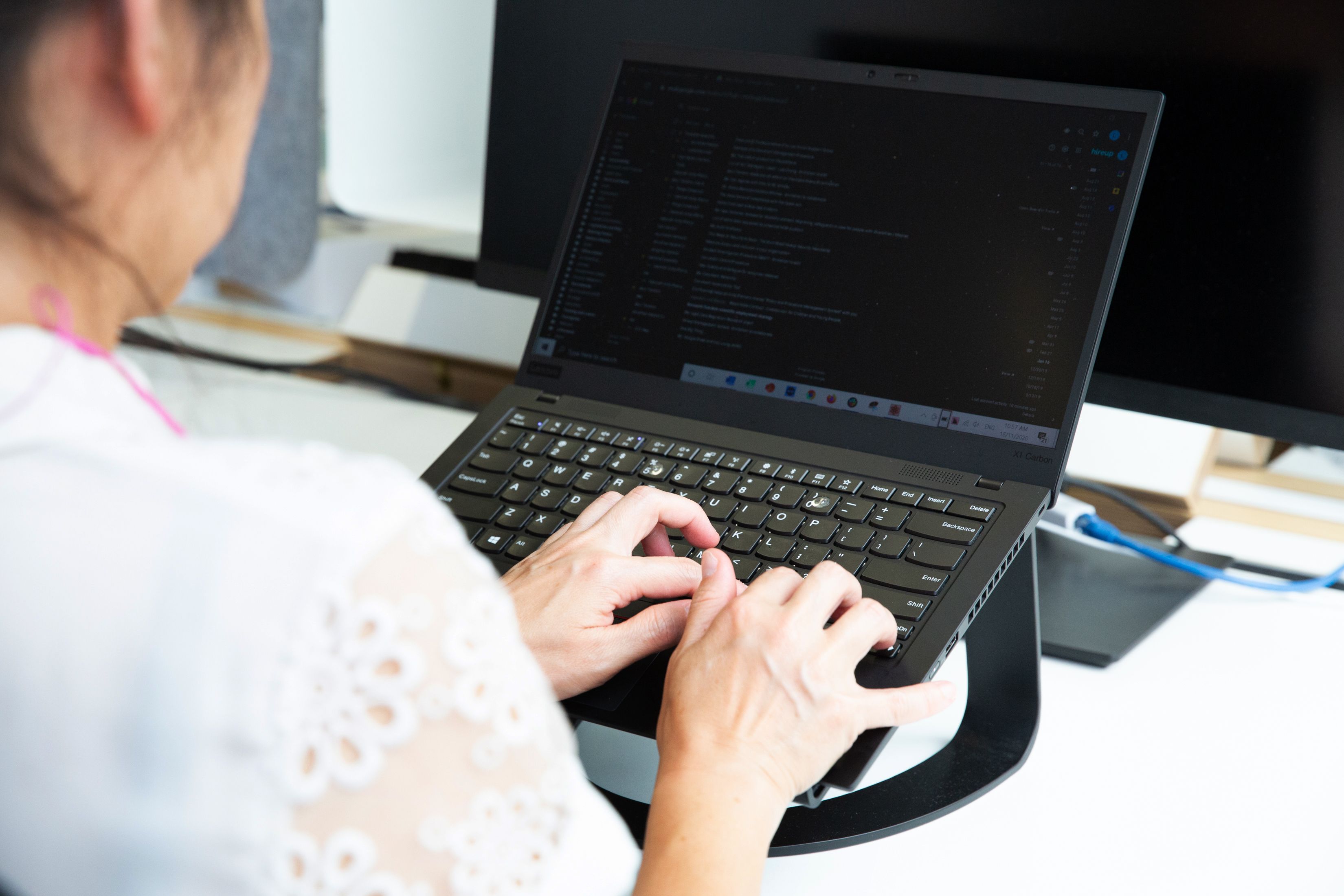Close up of a person typing on a computer
