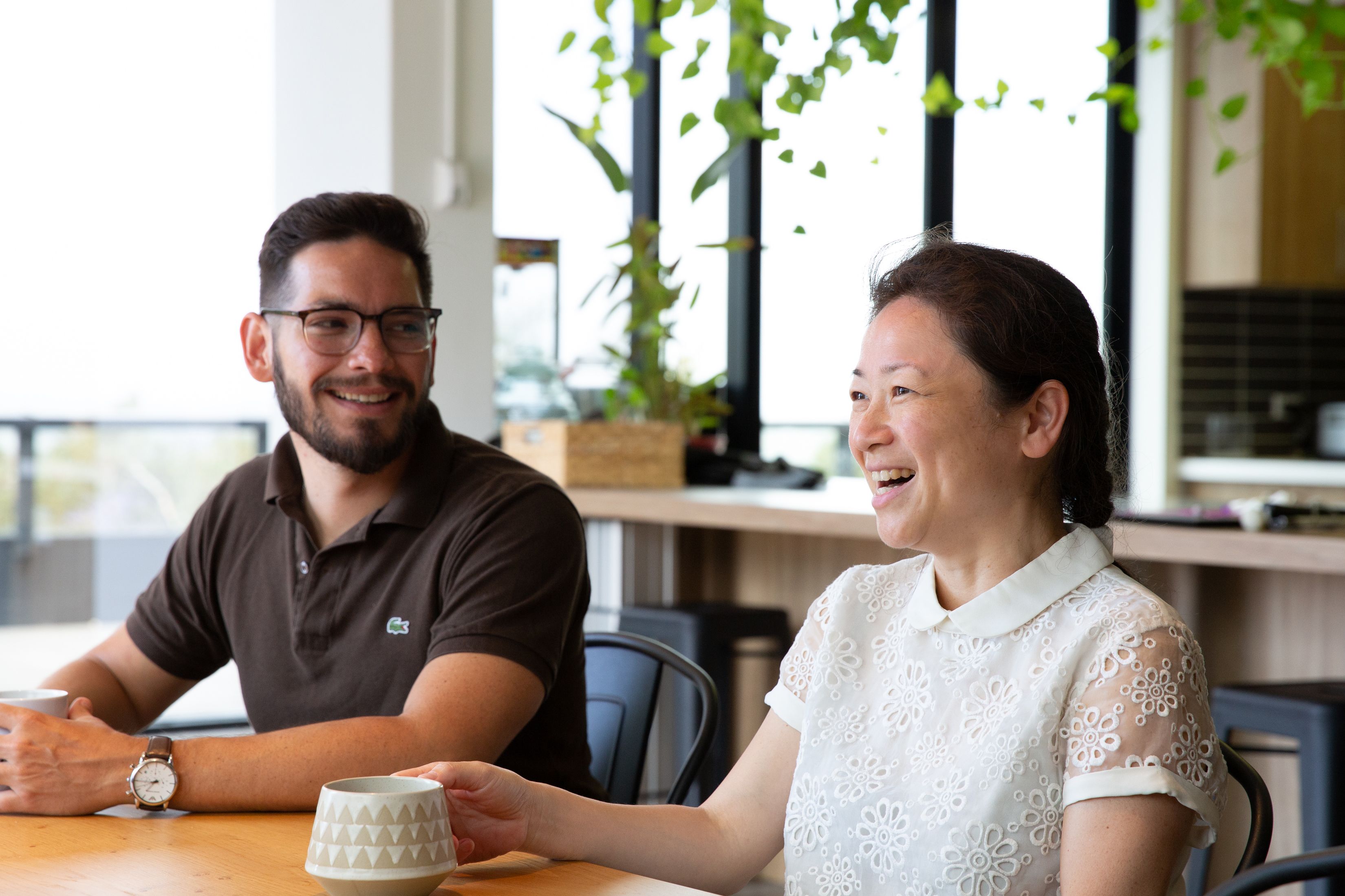 A Client sitting at a table smiling.