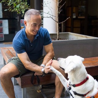 A puppy Raiser walking with their dog.