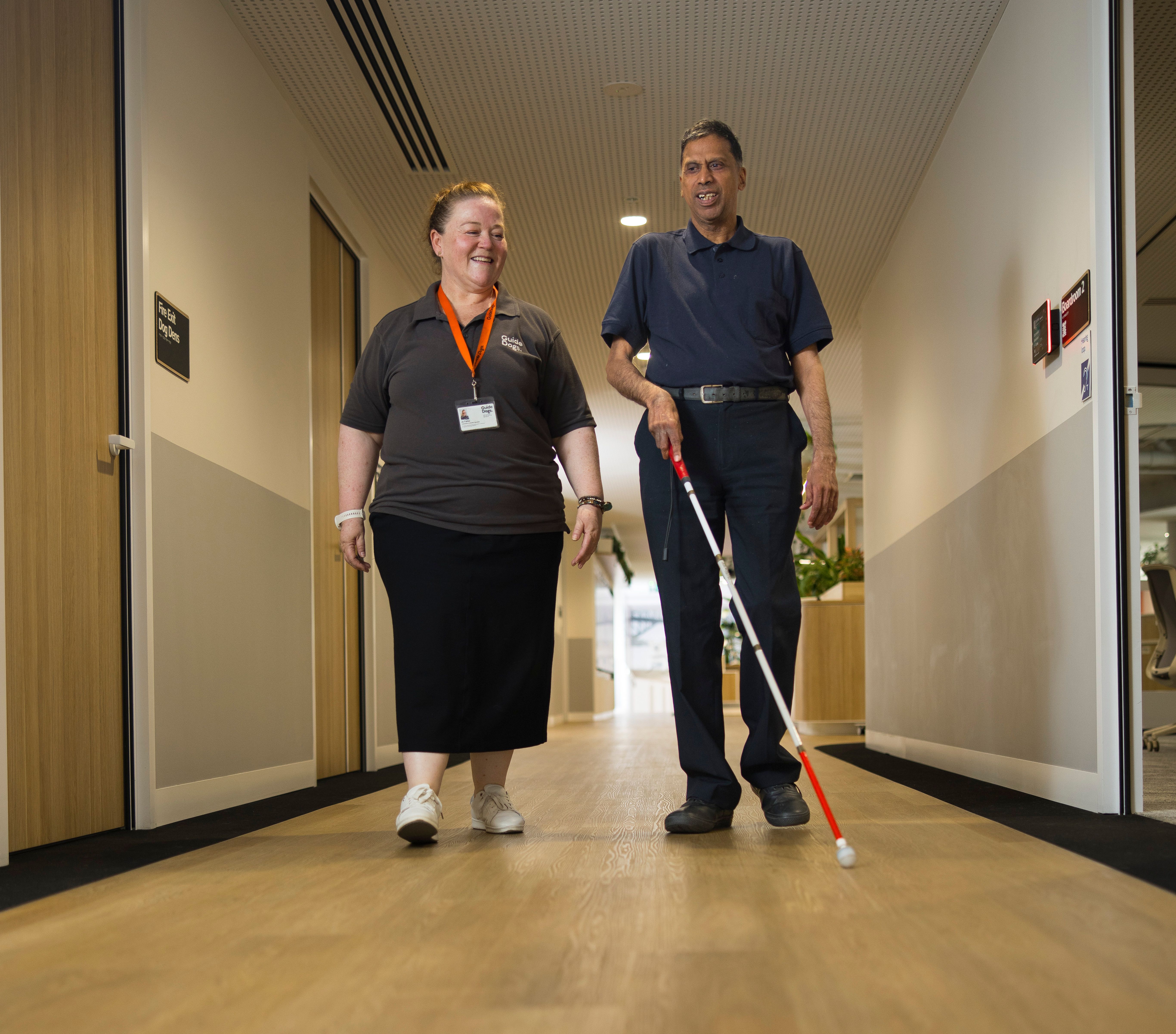 A Staff member and a Client walking together.