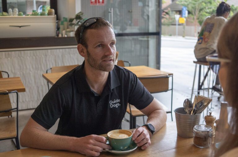 Dan Searle sitting in a cafe.