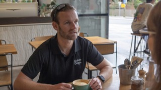 Dan Searle sitting in a cafe.