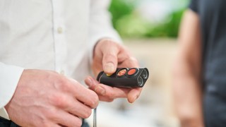 A person holding a miniguide.