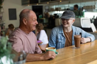 Two people sitting at a cafe.